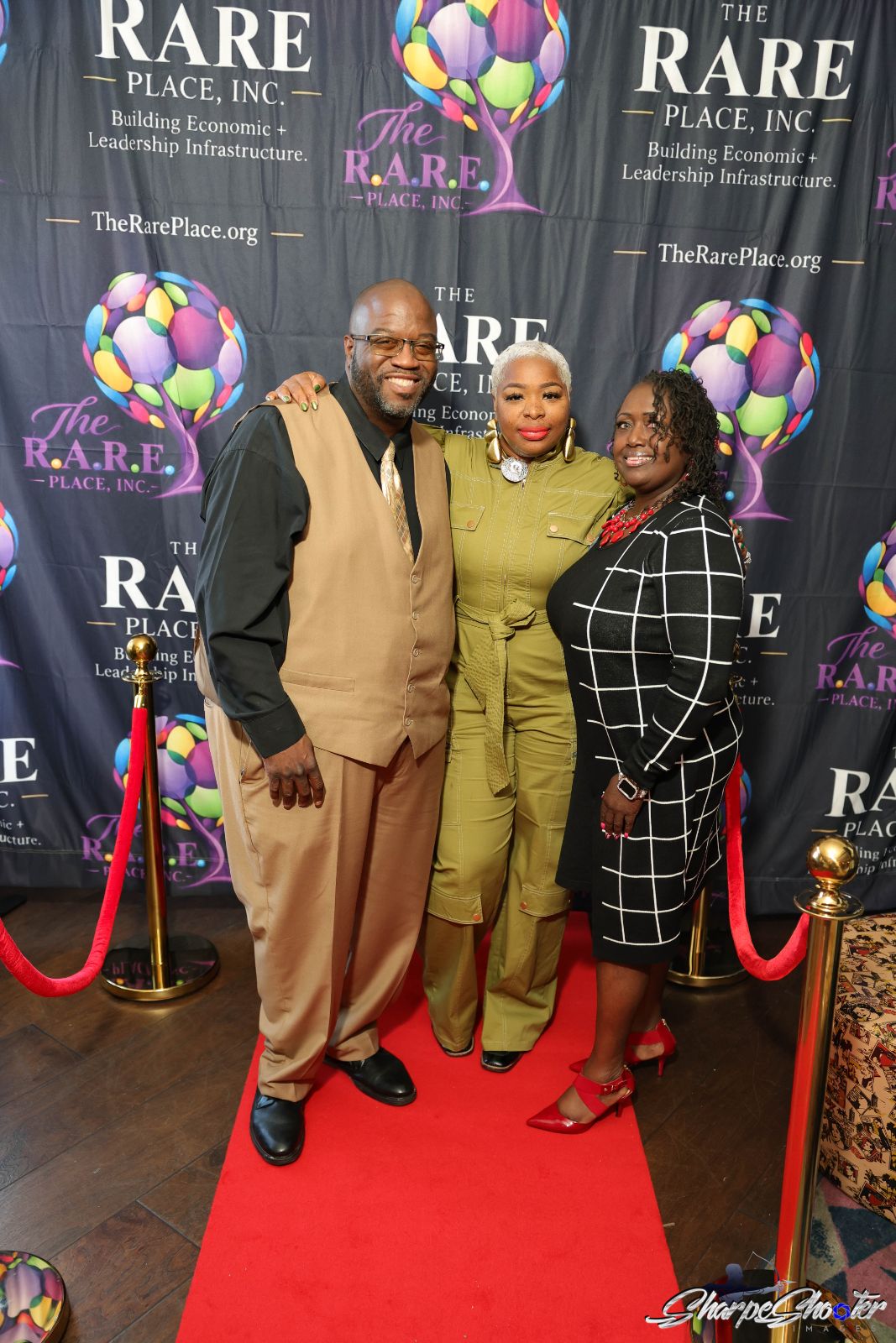 Talia Johnson-Huff with team members in front of The RARE Place, Inc. banner