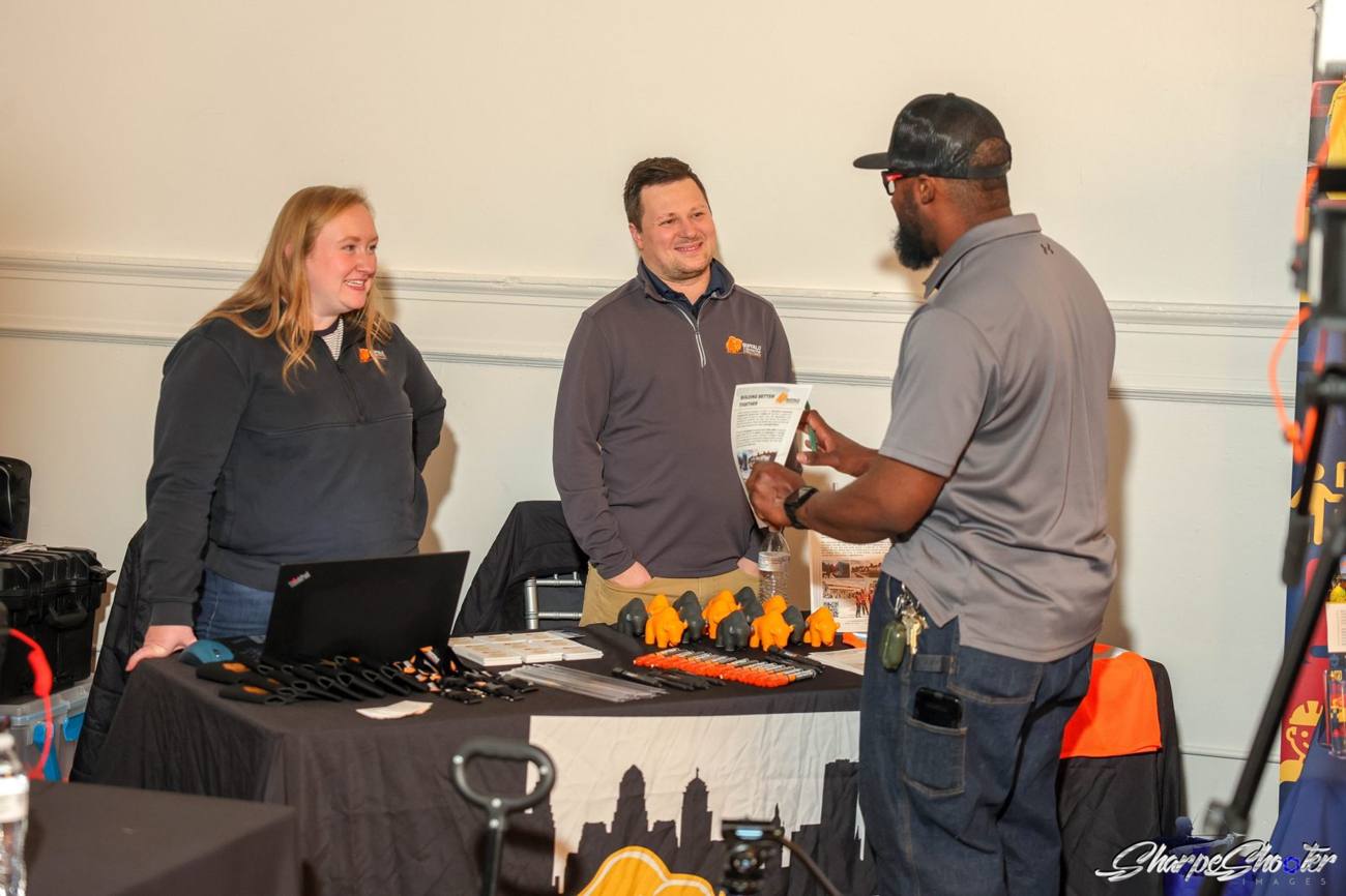 Buffalo Construction Consultants team talking with a contractor at their expo table