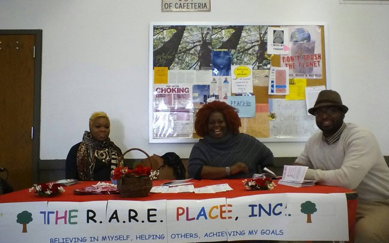 Christopher Huff and the RARE team at The RARE Place table in the Bennett High School cafeteria