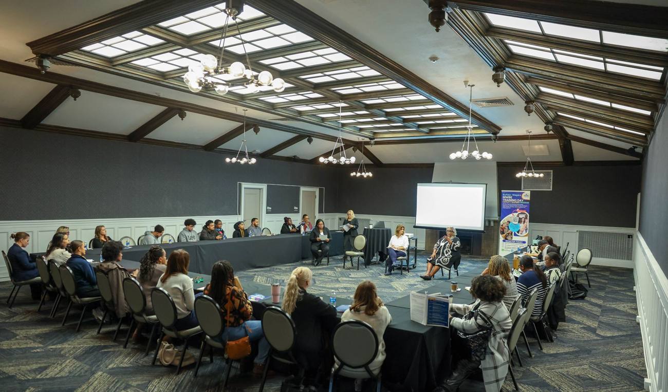 Capacity Building Program participants seated around a U-shaped table during a training session