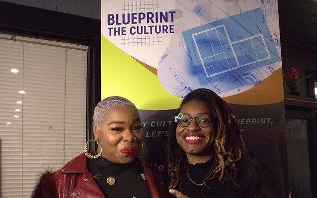 Talia with a guest in front of the Blueprint The Culture banner at Illuminate 2026
