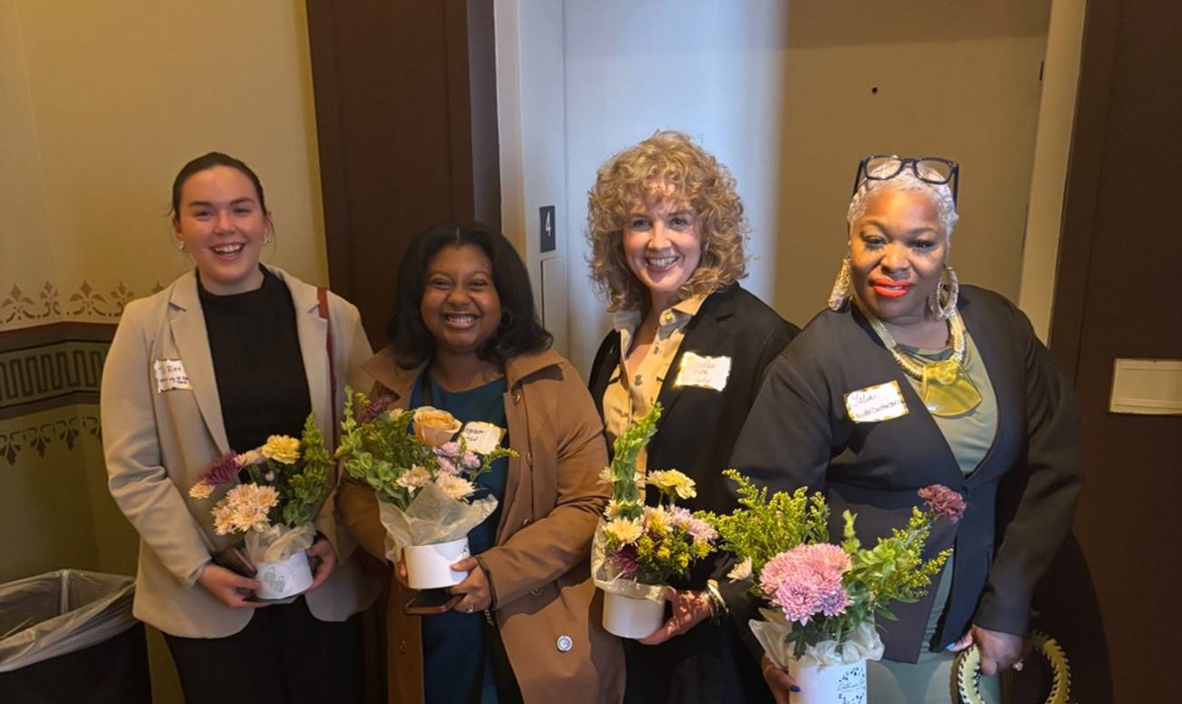 Talia, AmyRae Nessa and guests holding flower arrangements at the Richardson
