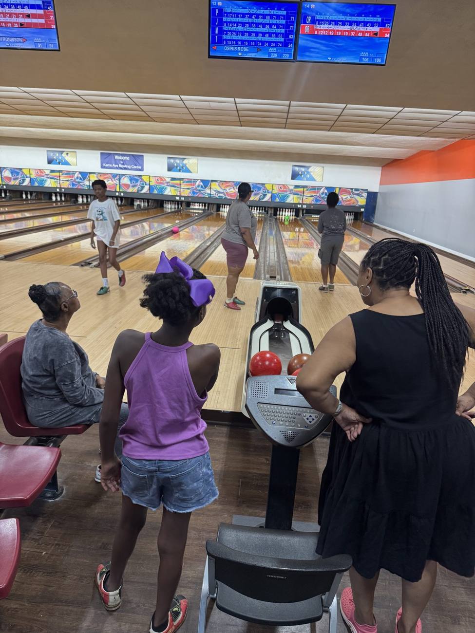 RARE Rollers bowling while family members cheer